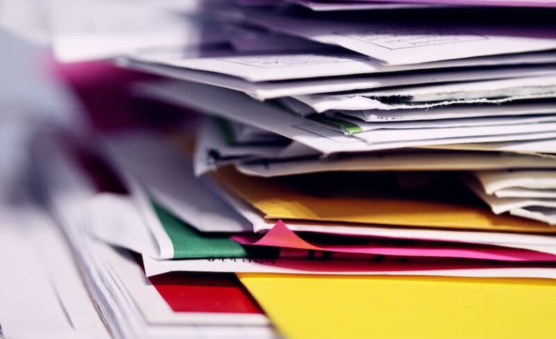 Stack of print marketing advertisements and direct mail