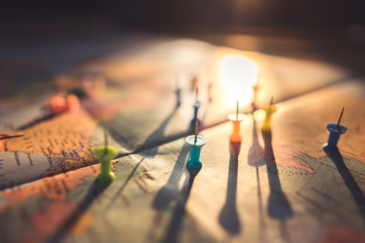 Map of world showing multiple locations with thumbtacks