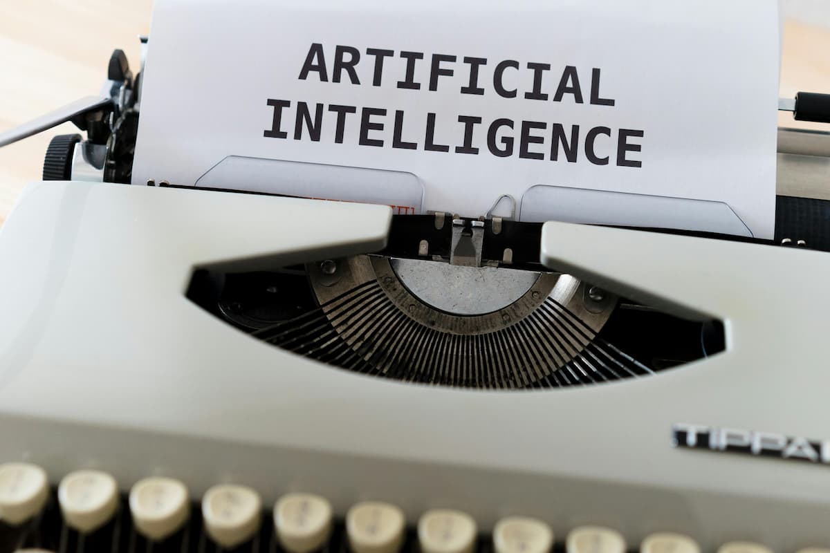 Typewriter and paper with artificial intelligence written on it