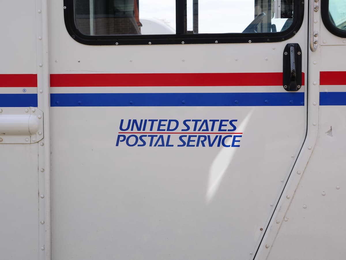 USPS mailing vehicle saying United States Postal Service on the side