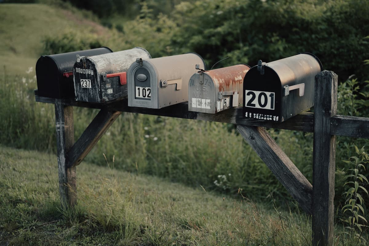 Mailboxes in a row filled with print marketing