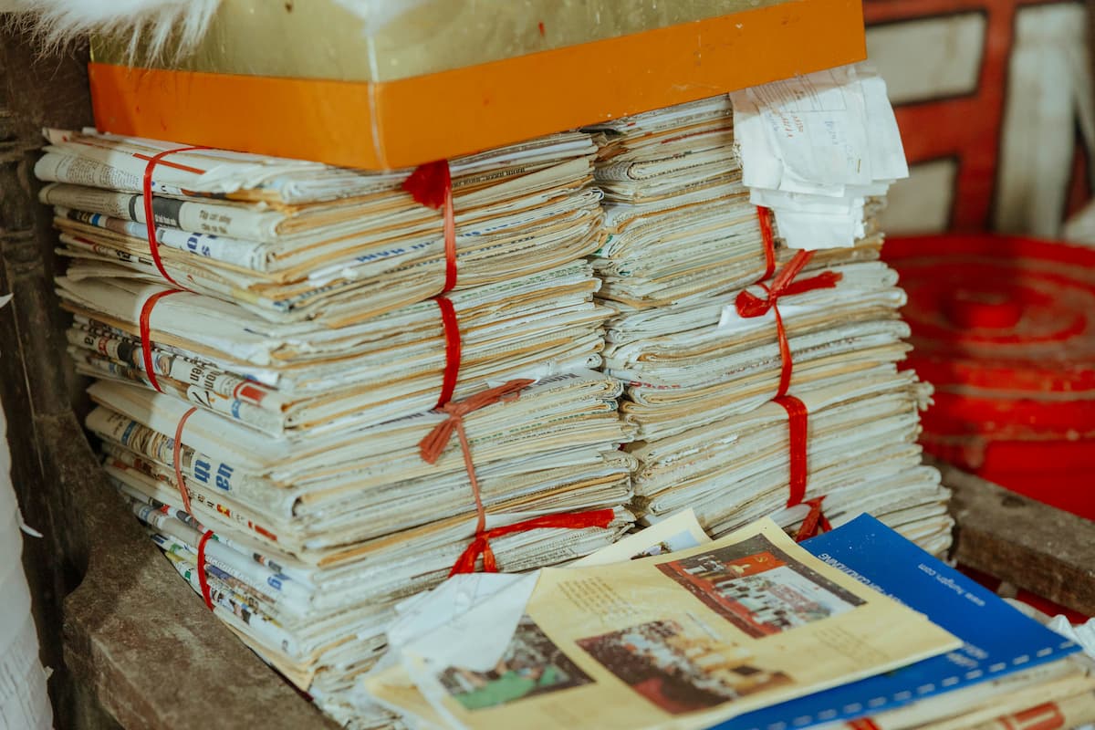Stack of newspapers and direct mail prints