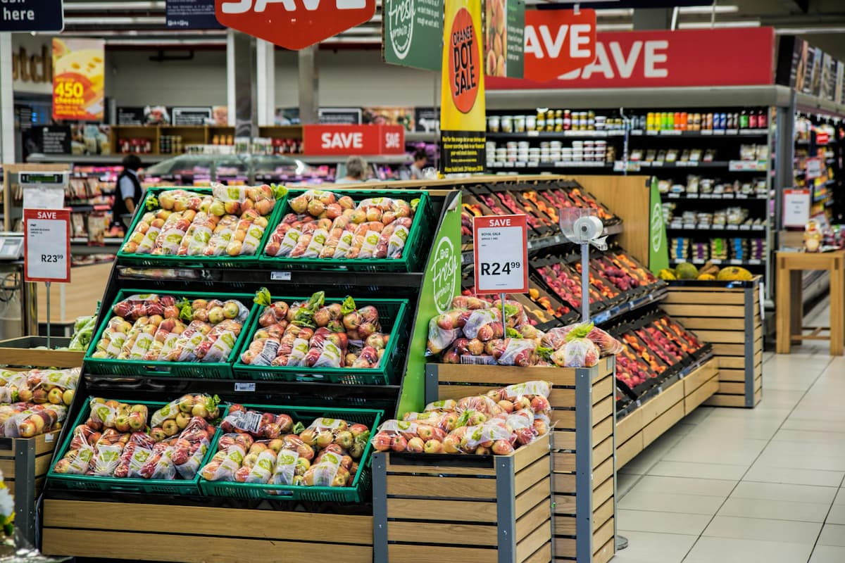 Grocery store shelves with marketing advertisements