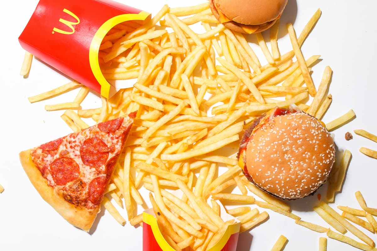 Quick service restaurant fast food with a burger, slice of pizza, and fries